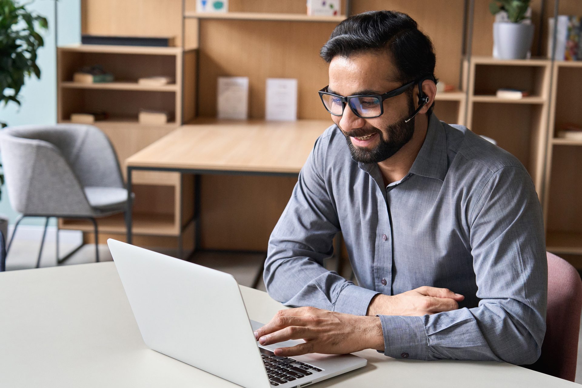 Sales professional completing an online course with a headset
